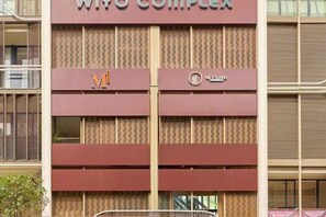 A multi-story building with the signage 'WICO COMPLEX' and a logo. - Express by M Village Global City, a brand of Modern Village Lifestyle (Ho Chi Minh City)