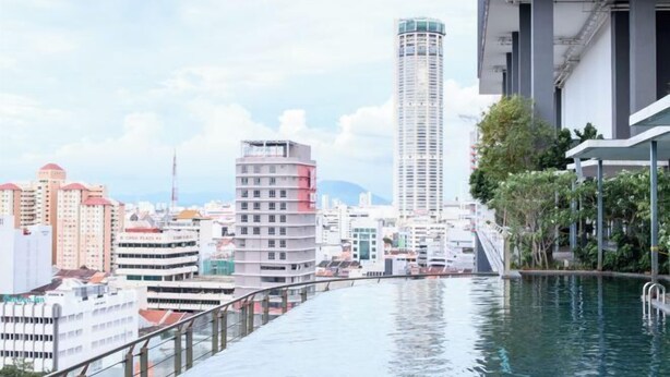 A modern hotel with a rooftop infinity pool overlooking a cityscape. - Mona Homes #6 Macalister 218, Georgetown Penang (George Town)