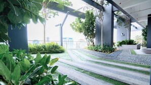A modern outdoor area with steps, greenery, and a clear view of the cityscape in the background. - Mona Homes #6 Macalister 218, Georgetown Penang (George Town)