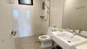 A bathroom with a toilet, sink, and shower. - Southkey Mosaic @ sweethome (Johor Bahru)