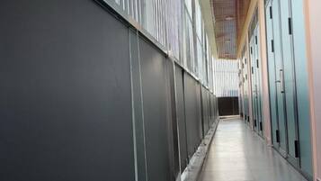 A corridor with lockers on one side and a wall on the other.