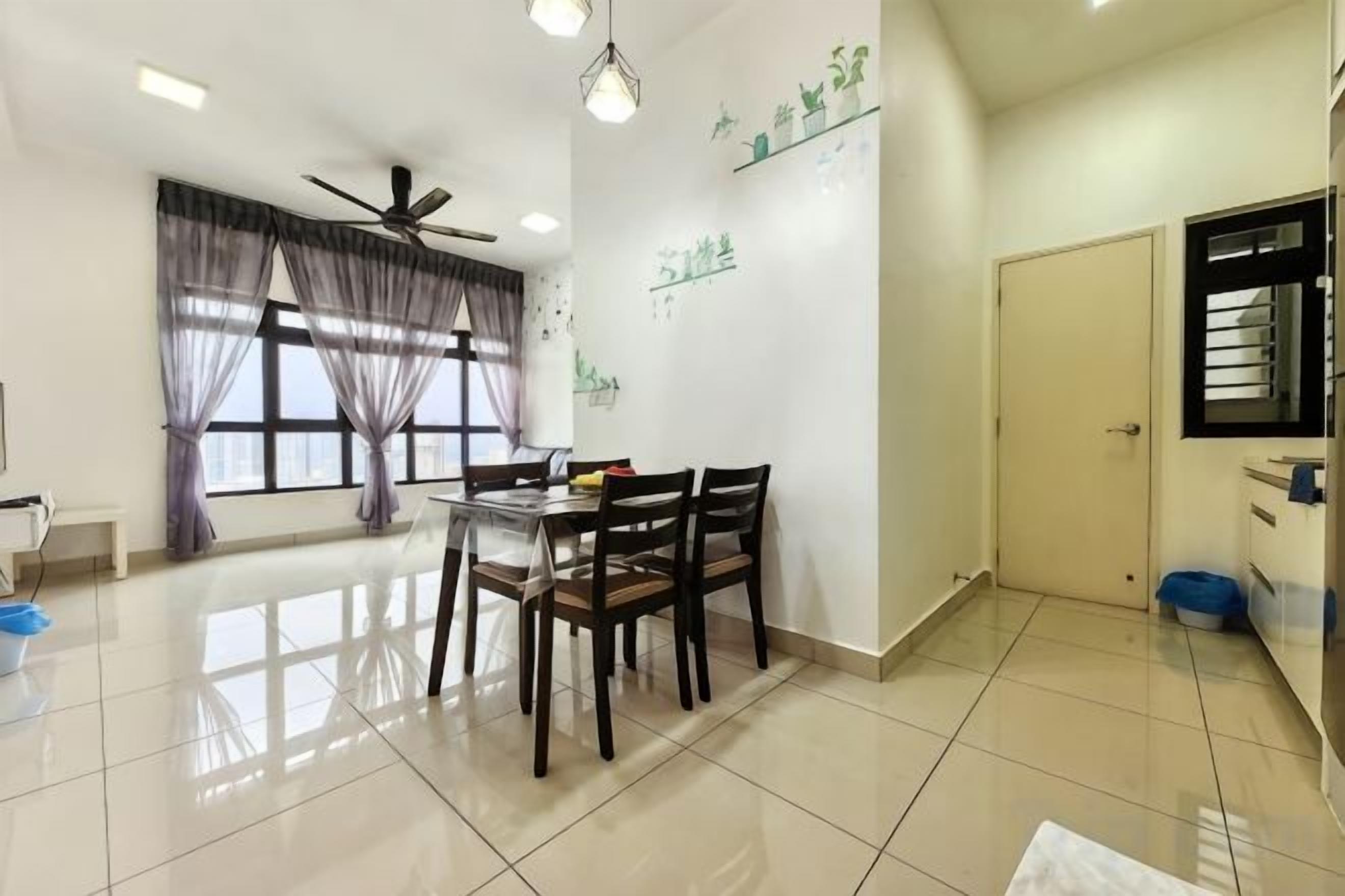 A dining area with a table and chairs, a ceiling fan, and a window with curtains.