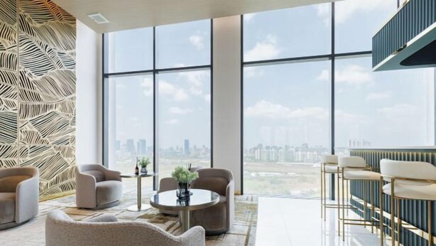 A spacious room with large windows offering a city view, comfortable seating, and a bar area. - Loft Apartments in Bangkok near Jodd Night Market [Nearly 711+ Central Pharam 9 Shopping Center] (Bangkok)