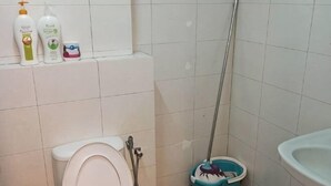 A bathroom with a toilet, a sink, and a mop bucket. - The Ceo Executive Loft - Work & Play (Bayan Lepas)