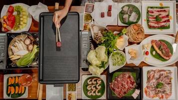 Ein Tisch mit verschiedenen Speisen und einem Grill.