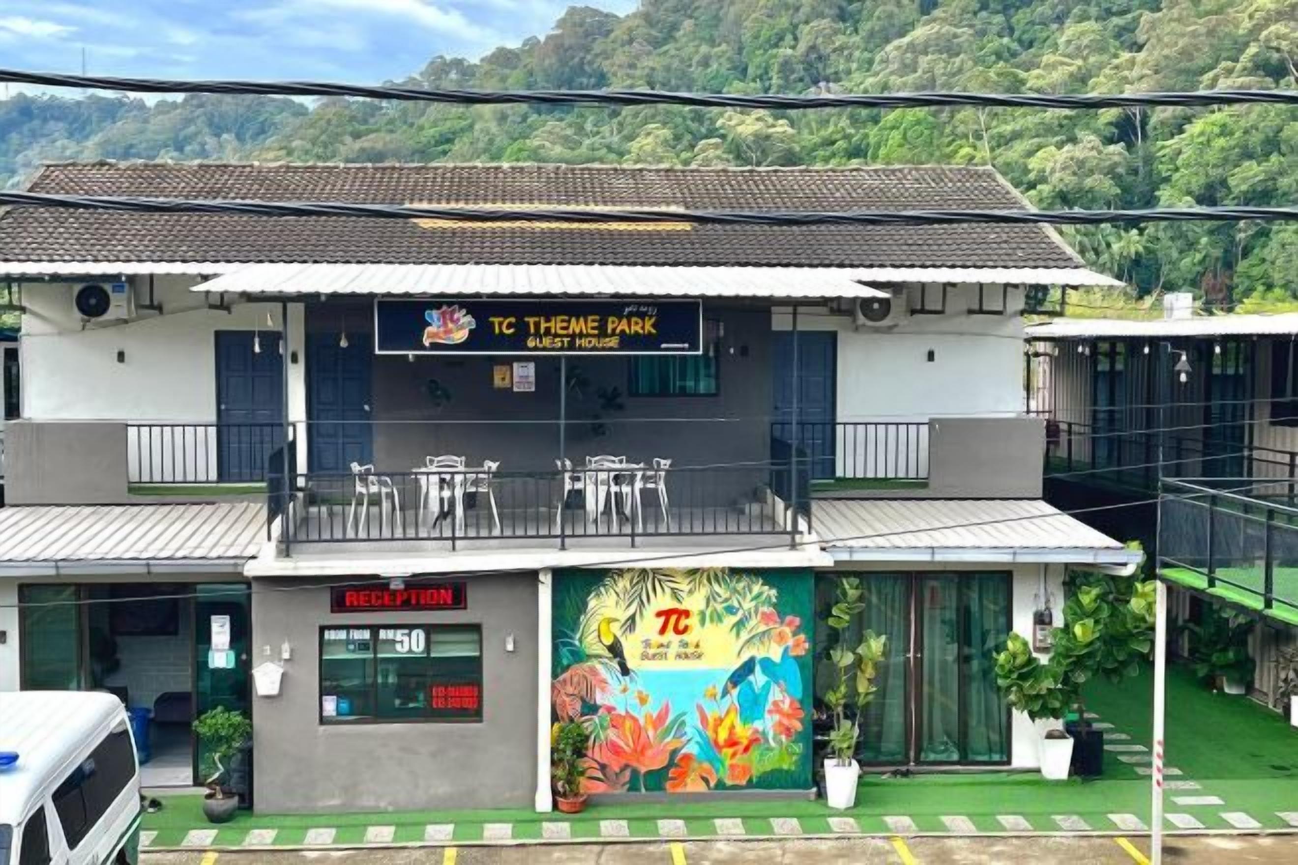 A two-story building with a reception area, a balcony, and a colorful mural.