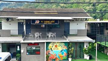 A two-story building with a reception area, a balcony, and a colorful mural.