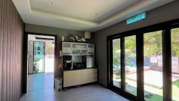 A modern kitchen with built-in appliances, a sliding glass door leading to a patio, and a sign indicating the name of the property.