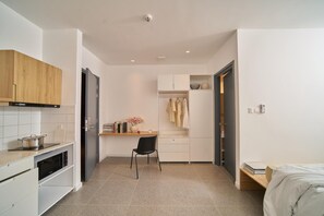 Una cocina compacta con estufa, horno y muebles de madera.