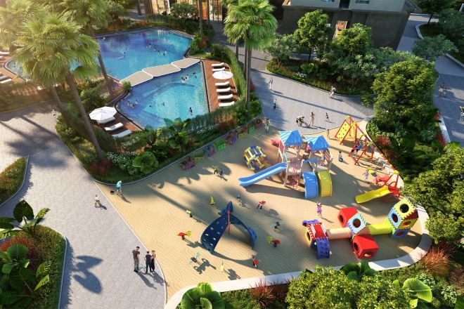A children's play area with slides and climbing structures, surrounded by a pool and greenery.