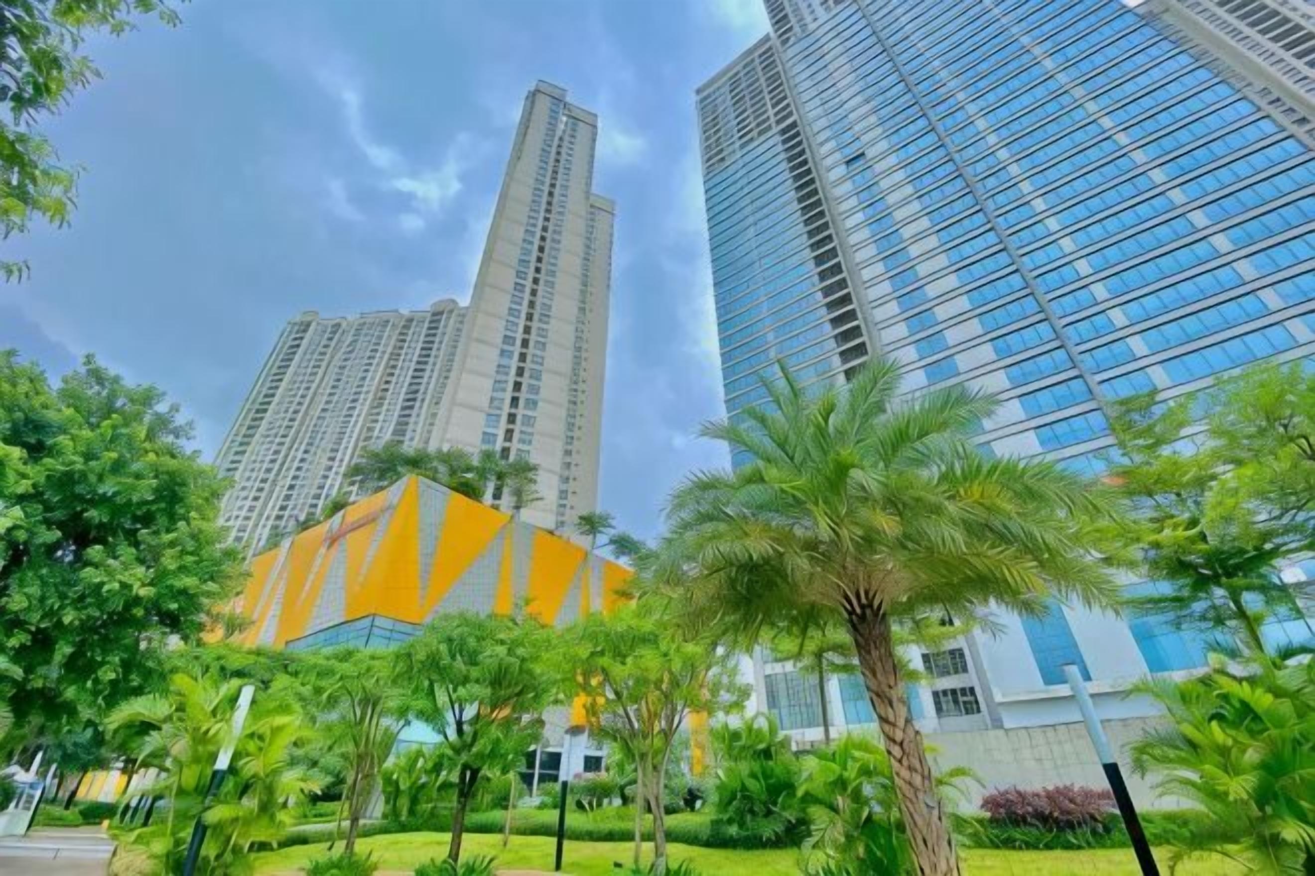 A modern building with a glass facade and a distinctive orange structure in the foreground.