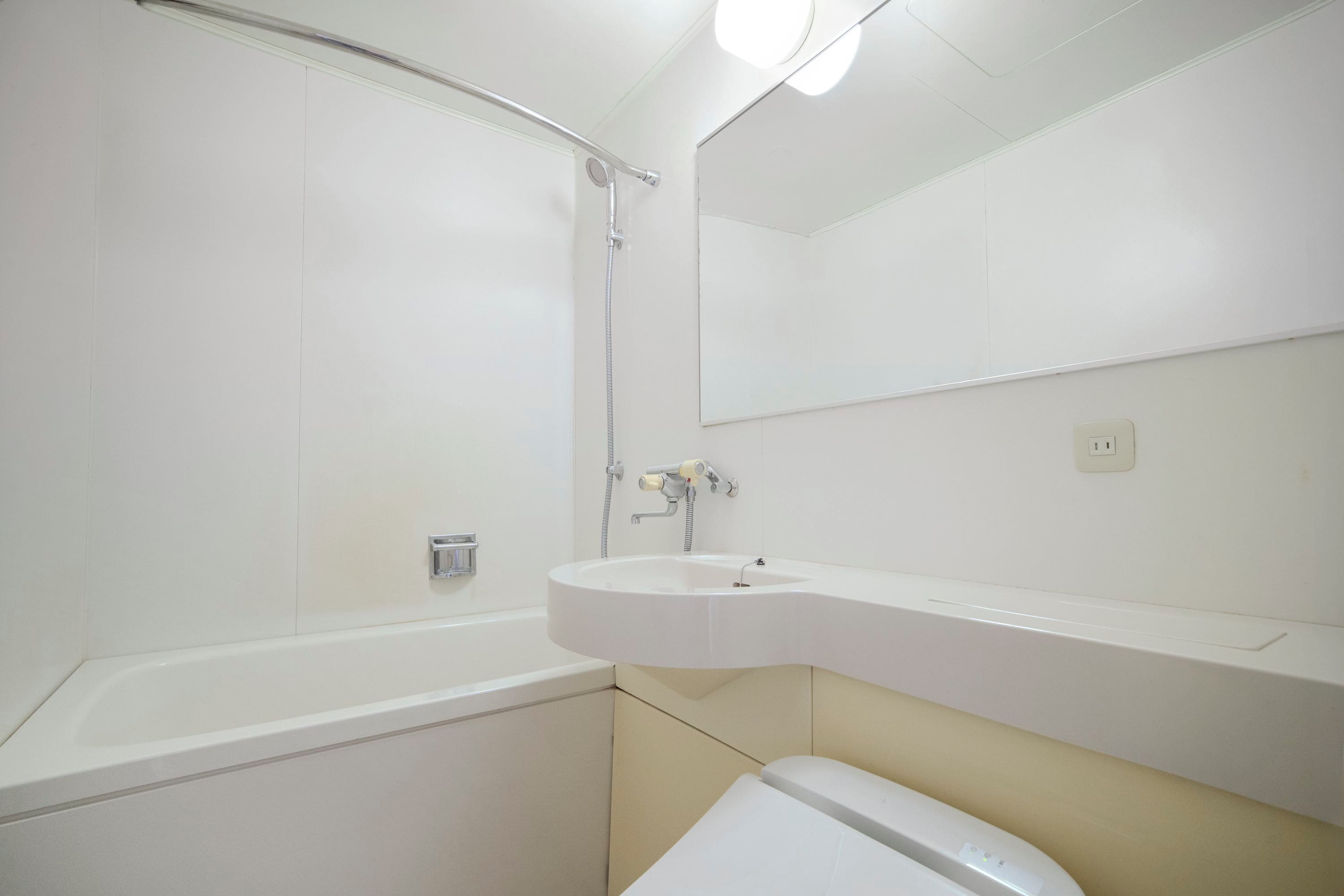 A bathroom with a bathtub, a sink, a toilet, and a shower.