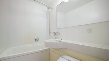 A bathroom with a bathtub, a sink, a toilet, and a shower.
