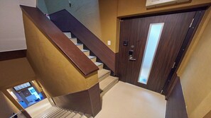 A staircase with a wooden handrail leading to a door with a frosted glass panel. - 4 min walk to Shinbashi Station, Ginza, Imperial Palace, Tokyo Tower / Max6 (Tokyo)