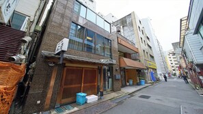 A narrow urban street with traditional and modern buildings, including a shop with a wooden door and a signboard. - 4 min walk to Shinbashi Station, Ginza, Imperial Palace, Tokyo Tower / Max6 (Tokyo)