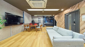 A modern interior with a dining area, sofa, and kitchen. - 4 min walk to Shinbashi Station, Ginza, Imperial Palace, Tokyo Tower / Max6 (Tokyo)