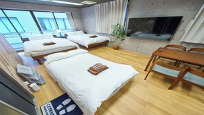 A hotel room with two beds, a dining table, a TV, and a potted plant. - 4 min walk to Shinbashi Station, Ginza, Imperial Palace, Tokyo Tower / Max6 (Tokyo)