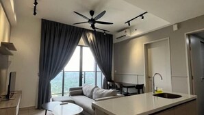 A modern living room with a sofa, a small round table, and a ceiling fan.