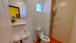 A small bathroom with a white sink, toilet, and shower. - leader residences (Bang Phli)