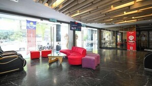 A modern lobby with a glass entrance, red and purple seating, and a digital sign displaying 'RM5'. - Kingston Hotel 2 @ Setapak (Kuala Lumpur)