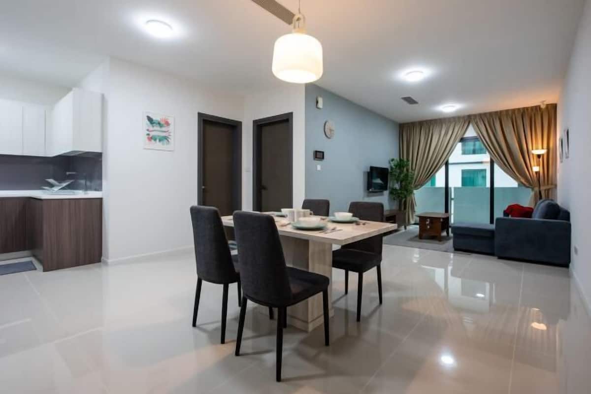 A modern apartment with a dining area, kitchen, and living space.