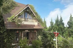 A traditional wooden house with a steeply pitched roof, surrounded by trees. - Thi Tran Co Da Lat (Dalat)