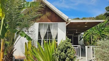 A two-story building with a covered porch and a sign that reads 'Bungalow Road.'