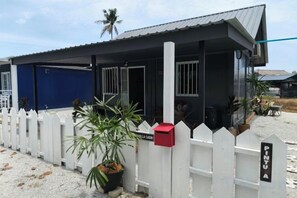 A building with a white picket fence, a red mailbox, and a sign that reads 'PINJA'. - The Vanilla Cabin 2 (Kuala Terengganu)