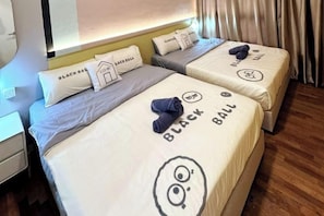 Two beds with 'BLACK BALL' branding, a bedside table, and a headboard with a light fixture. - L22-ParadigmMall Residence Skudai JB 3R2B-10pax by UcomeHomestay (Tebrau)