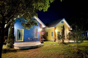 A two-story house with a porch and a small garden. - Panor Coffee House & Restaurants (Mae Chan)
