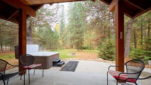 An outdoor patio with a hot tub, two chairs, and a fire pit. - Mountain Lodge w/ Hot Tub + Private River Beach (Leavenworth)
