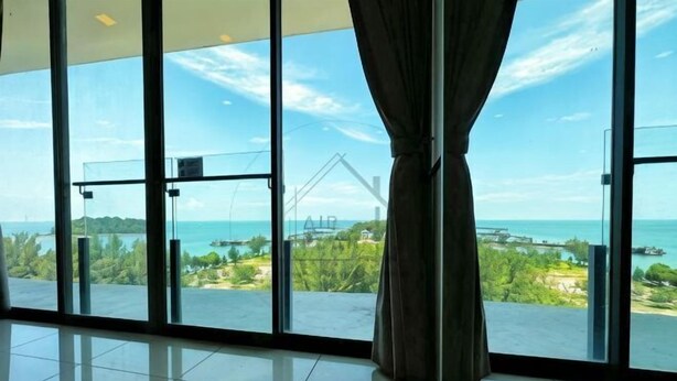 A room with large glass windows, a curtain, and a view of the sea and greenery. - PD D’Wharf Seaview & Sunset Suite (up to 6 Pax) (Port Dickson)