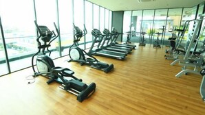 A gym with exercise equipment, large windows, and a wooden floor. - PD D’Wharf Seaview & Sunset Suite (up to 6 Pax) (Port Dickson)