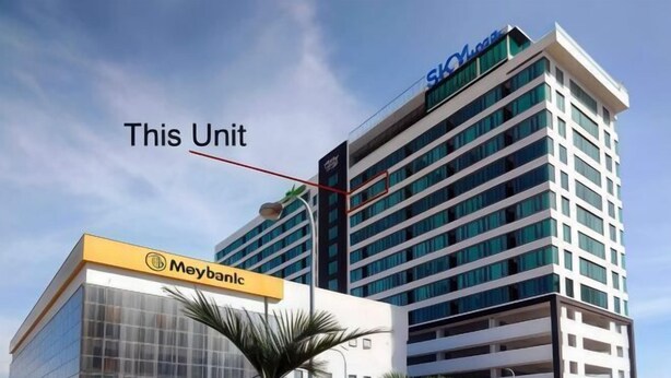 A modern building with a glass facade and a sign for 'Meybank'. - Urban Retreat @ KK Sky • Pool • Parking (Kota Kinabalu)