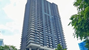 A tall, modern building with a grid-like facade and multiple balconies. - Anggun KLCC Spacious Studio Steps to Monorail & LRT FREE Parking (Kuala Lumpur)