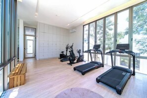 A spacious room with a treadmill, stationary bike, and elliptical machine. - Residence Villa｜Modern 3 Bedroom Pool Villa｜Warm Plus (Phuket)