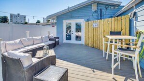 A deck with a sofa, chairs, and a table. - Walk to Ocean! Home w/ Large Yard in Ormond Beach (Ormond Beach)