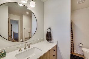 A bathroom with a large mirror, a white sink, and a towel rack. - Built in 2025: Parowan Escape w/ Views! (Parowan)