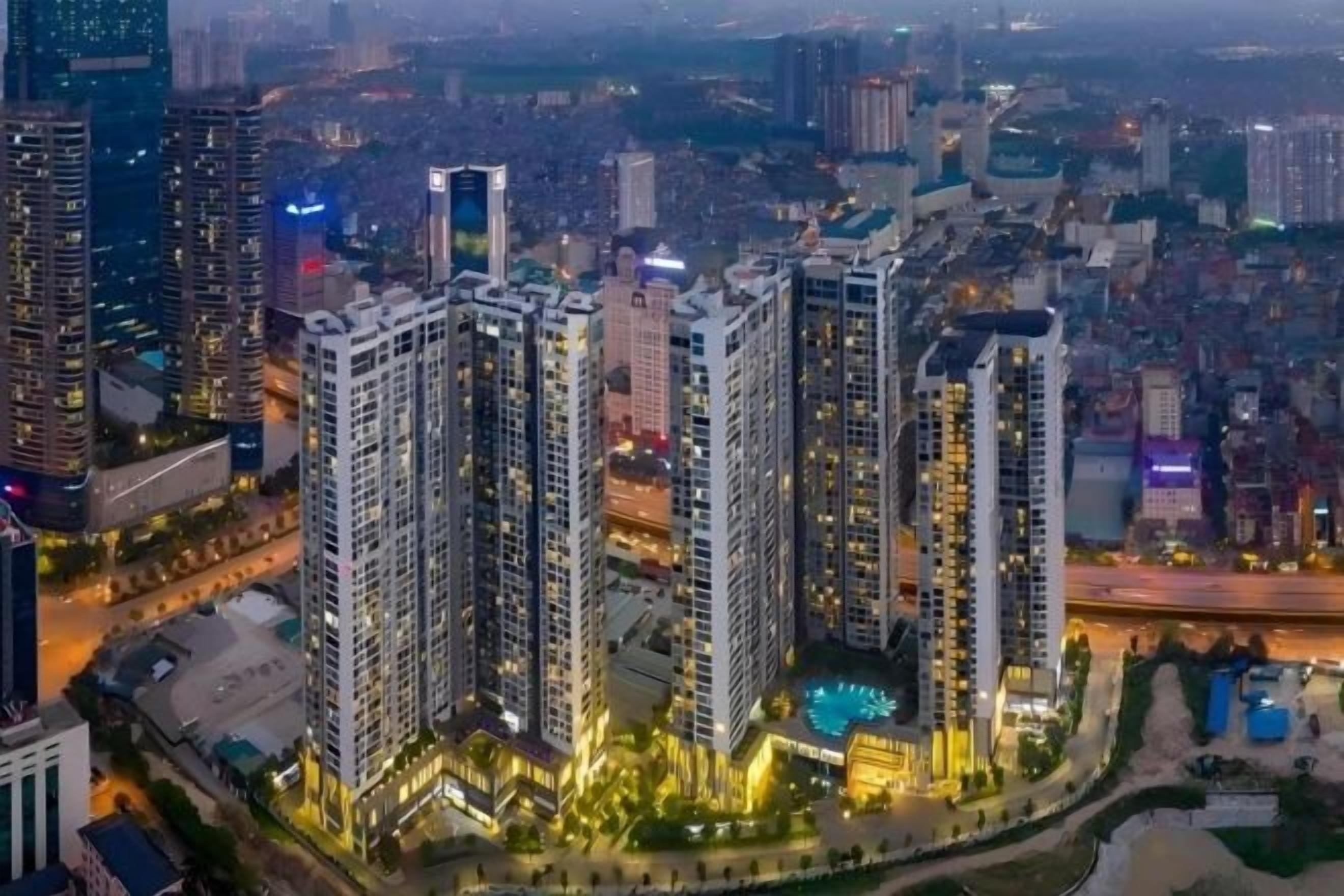 A high-rise residential building complex with multiple towers, surrounded by other buildings and roads.