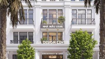 A building with a sign reading 'NHA MAU LOUIS' and 'AA DESIGN CENTER' on the facade.