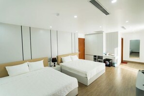 A modern hotel room with two beds, a large mirror, and a wardrobe. - NHAT MINH HOTEL (Lang Son)