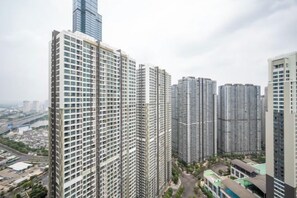 A high-rise building with multiple floors, surrounded by other tall buildings. - VINHOMES CENTRAL PARK LUXURY APARTMENT (Ho Chi Minh City)
