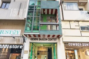 A multi-story building with a storefront labeled 'GEMINI SAIGON CENTER' and adjacent shops including 'JUSTAY' and 'COWBOY ZONE'. - Gemini Saigon Center - New & Quiet Near Bui Vien Walking Street (Ho Chi Minh City)