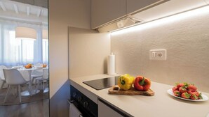 A modern kitchen with a built-in stove, a cutting board with bell peppers, and a plate of strawberries. - City / Village Apartment in Cortona with 1 bedrooms sleeps 2 (Cortona)