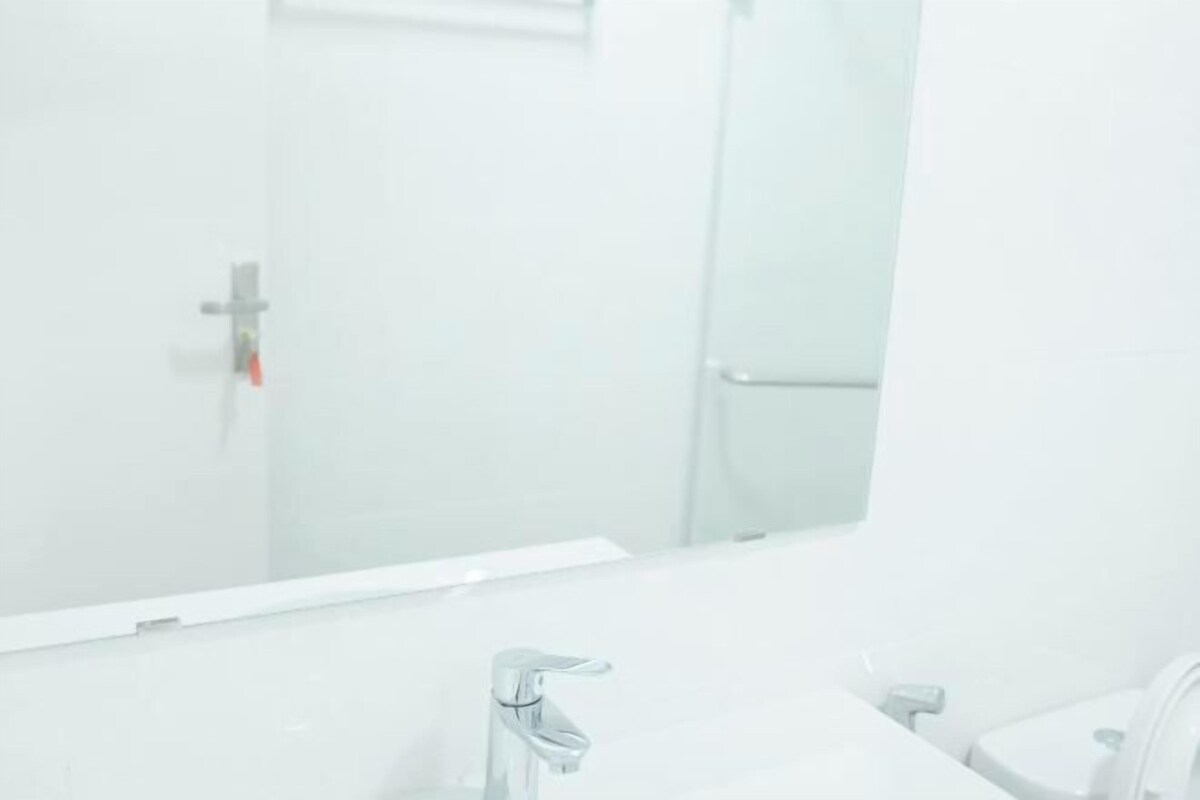 Une salle de bain avec un miroir, un lavabo et des toilettes.