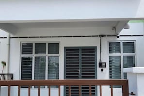 A white building with a balcony, large windows, and a security camera. - LestariHome2, KLIA Sepang (Sepang)