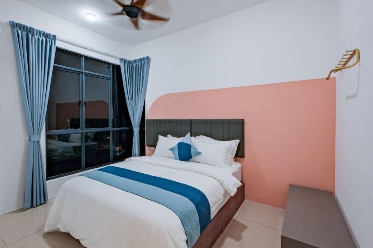 A bedroom with a bed, curtains, a ceiling fan, and a window.