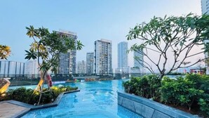 A rooftop pool with a view of high-rise buildings. - LUMIERE RIVERSIDE CONDOTEL IN CENTER HO CHI MINH (Ho Chi Minh City)