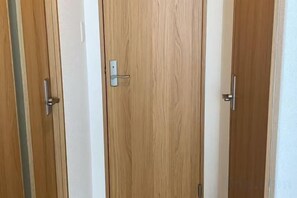 A set of wooden doors with a simple handle design. - LuckyHouse yorokobiya 901 (Osaka)