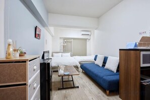A modern hotel room with a bed, a sofa, a desk, and a TV. - Excellence Osakajo Koen (Osaka)